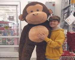 Gabe loves soft toys and got a giant monkey to play with.